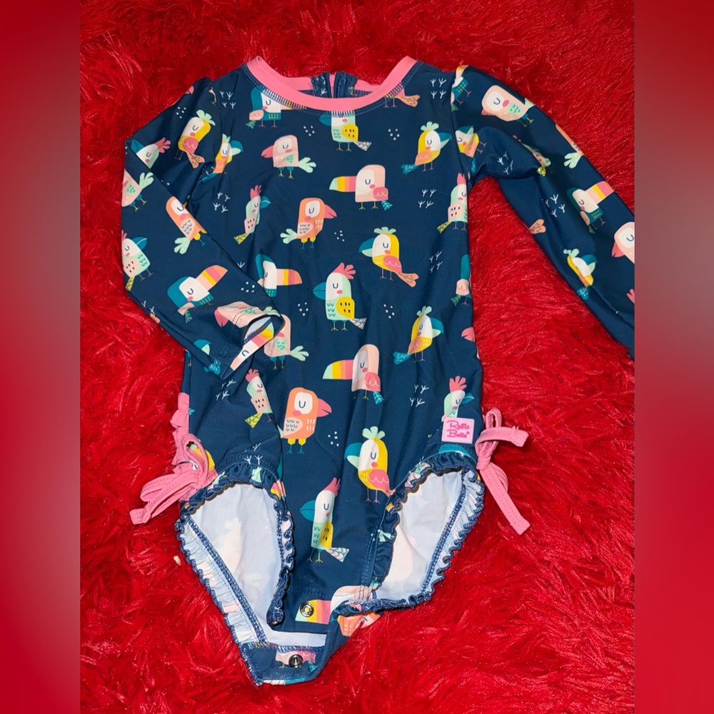 Ruffle Butts Navy One-Piece with Multicolor Tropical Bird Print and Pink Trim
